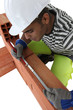 Mason measuring length of brick