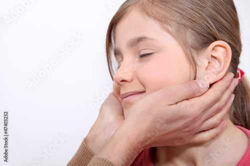 Photo: Young girl enjoying a massage Young girl enjoying a massage