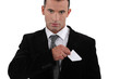 businessman putting a visit card in his pocket