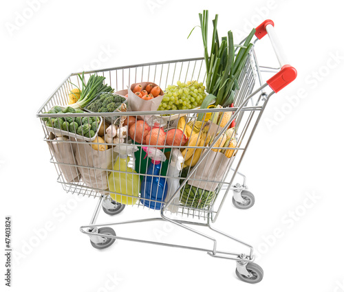 Photo: Shopping cart full of grocery isolated on white background Shopping cart full of grocery isolated on white background