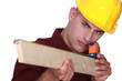craftsman measuring a board