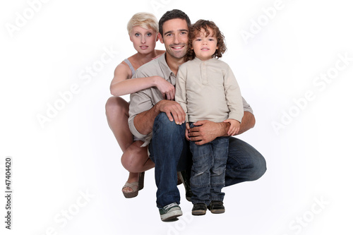 Photo: Young family posing in a studio Young family posing in a studio