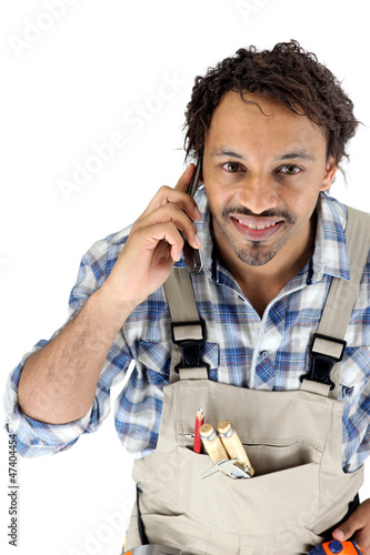 Photo: Tradesman talking on his mobile phone Tradesman talking on his mobile phone