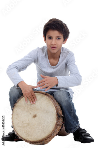 Photo: Boy playing a djembe Boy playing a djembe