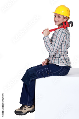 Photo: A female mechanic with a wrench. A female mechanic with a wrench.