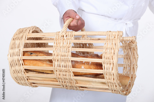 Photo: Baker with a basket of bread Baker with a basket of bread