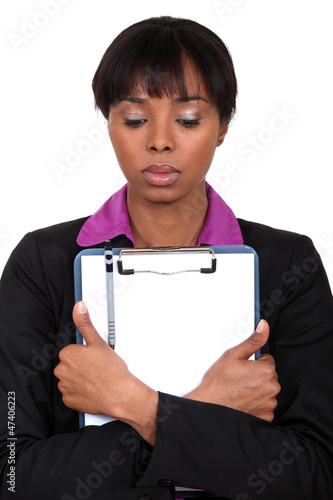 Photo: Sad woman holding a clipboard Sad woman holding a clipboard
