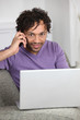 Man with computer talking on the phone