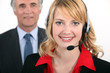 Smart woman wearing a telephone headset
