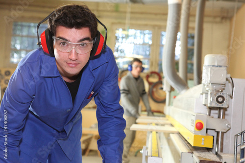 Photo: apprentice working in a factory apprentice working in a factory