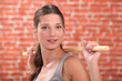 Woman stretching using wooden pole