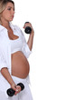 Pregnant woman using hand weights