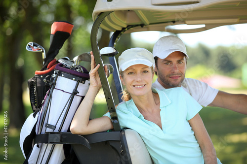 Photo: Couple in golf cart Couple in golf cart