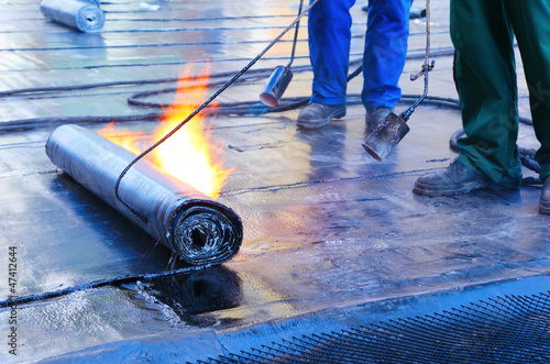 Photo: men Crout roof with hot tar men Crout roof with hot tar