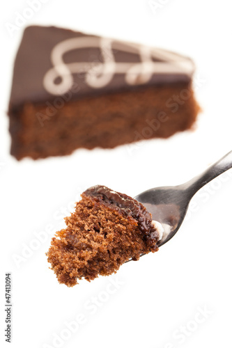 Photo: Kuchengabel mit Sachertorte im Hintergrund Kuchengabel mit Sachertorte im Hintergrund