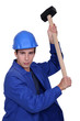 Man wielding sledge-hammer