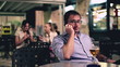 Young man talking on cellphone in the restaurant, evening