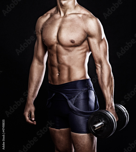 Photo: Portrait of handsome man posing on black background Portrait of handsome man posing on black background