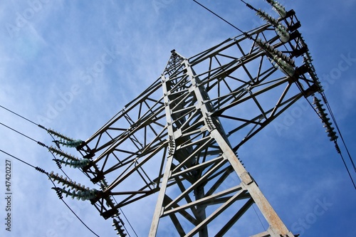 Photo: Electricity pylon against blue cloudy sky Electricity pylon against blue cloudy sky