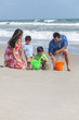 Mother Father & Children Family Playing on Beach