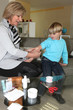 Woman sticking a plaster on a child's arm