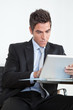 Young Businessman Using Digital Tablet In Office