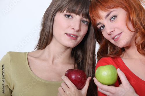 Photo: Girls holding apples Girls holding apples