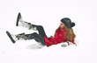 Happy girl with cap and gloves playing with snow in the winter l