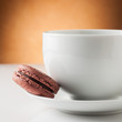 Cup of coffee with a chocolate macaron