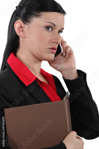 Photo: A businesswoman over the phone. A businesswoman over the phone.
