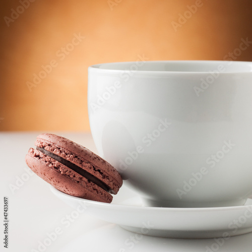 Photo: Cup of coffee with a chocolate macaron Cup of coffee with a chocolate macaron