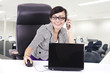 Business executive on phone with laptop