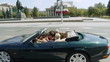 Video: Happy young couple riding in a cabriolet through the city. Happy young couple riding in a cabriolet through the city.