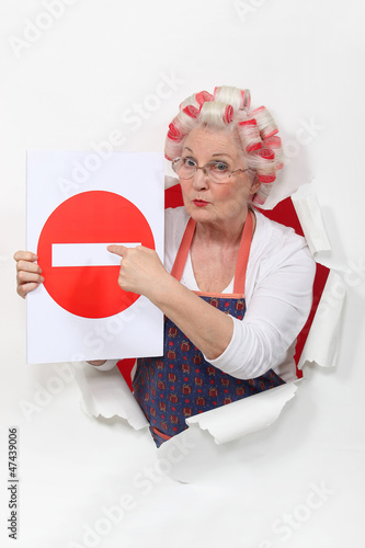 Photo: Woman with curlers and no trespassing sign Woman with curlers and no trespassing sign