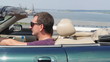 Video: Happy young couple riding in a cabriolet on the bridge. Happy young couple riding in a cabriolet on the bridge.