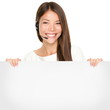 Beautiful Asian woman holding a blank sign