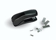 Standard office stapler on a white bacground. Image is black & w