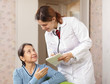 friendly doctor asks mature patient feels