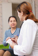 mature woman complaining to doctor about feels