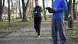 Female jogger with personal trainer in park, super slow motion