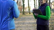 Male jogger with personal trainer in park, super slow motion