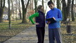 Female jogger with personal trainer in park, crane shot