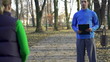 Video: Female jogger with personal trainer in park, super slow motion Female jogger with personal trainer in park, super slow motion