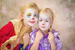Photo: Two clown girls painted Two clown girls painted