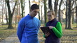 Jogger and personal trainer outdoors, super slow motion