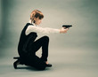 blonde holding a gun