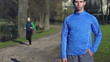 Portrait of young jogger in park, super slow motion