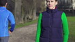 Portrait of young jogger in park, super slow motion