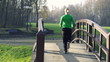 Woman jogging in park, crane shot, super slow motion