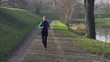 Woman jogging in park, crane shot, super slow motion